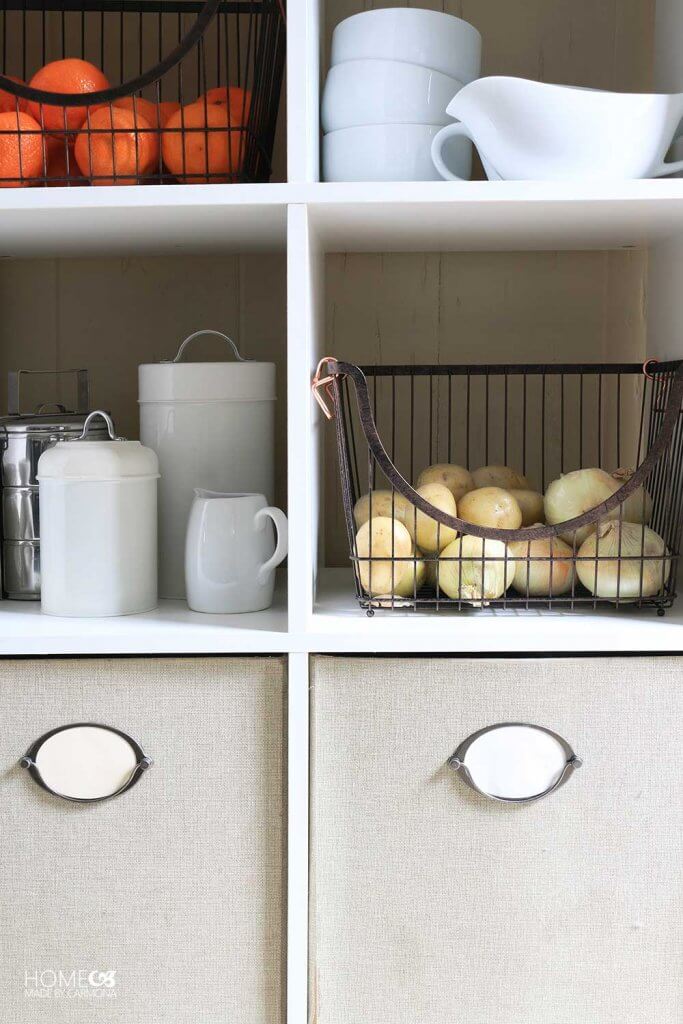 Pantry closet with bins and metal baskets