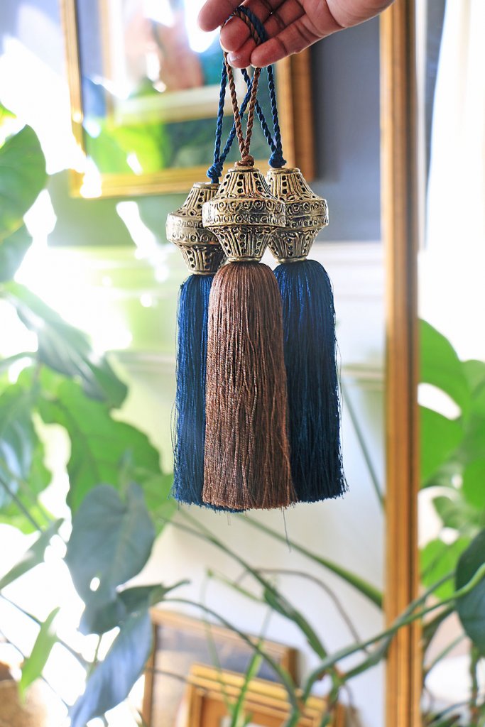 Three decorative tassels with metal tops