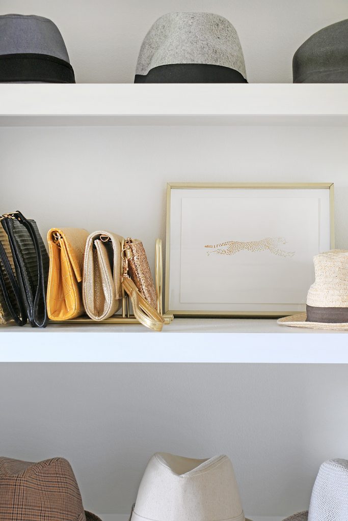 Closet shelf organized with purses and hats