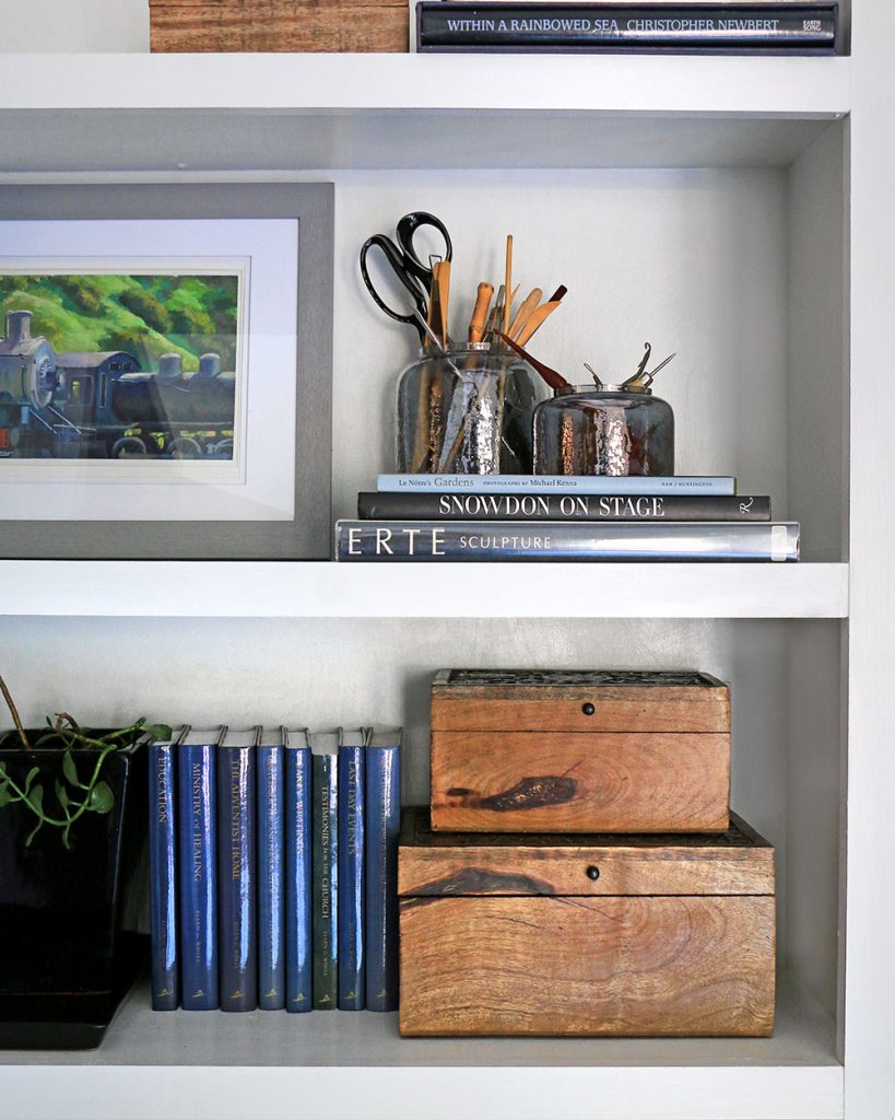 bookcase vignette with decorative boxes