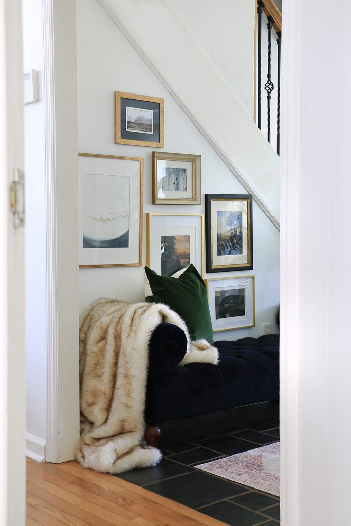 Hallway corner with bench and framed pieces