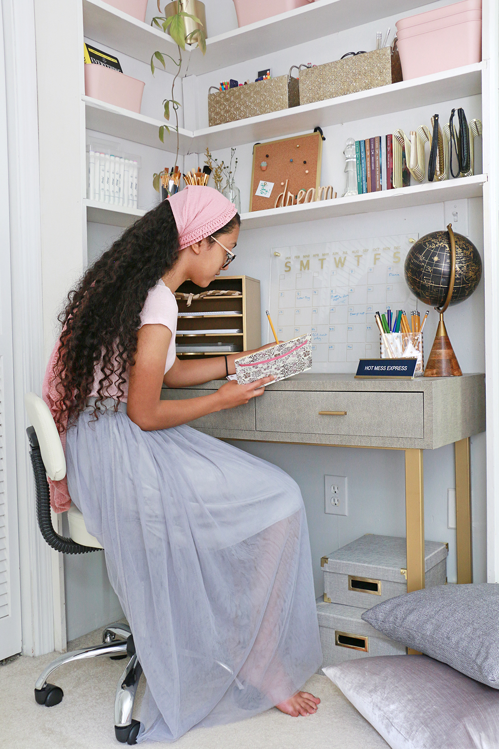 Teenager sitting at styled desk