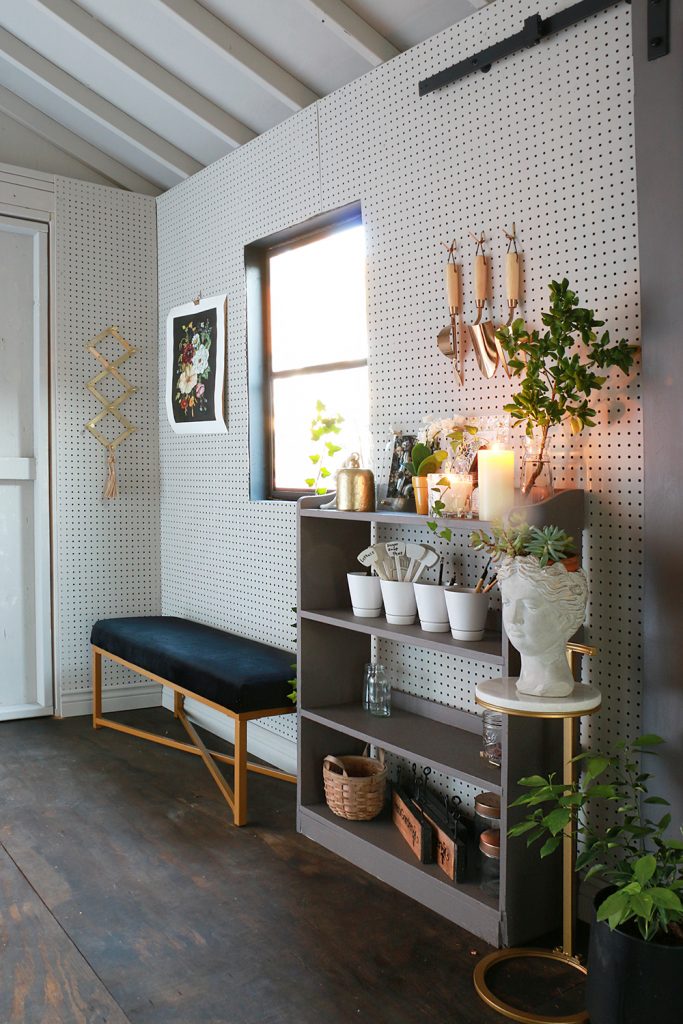 Shed with pegboard and hanging tools and poster