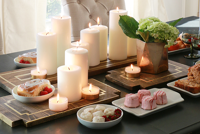 Candles on a stylish wooden board holder