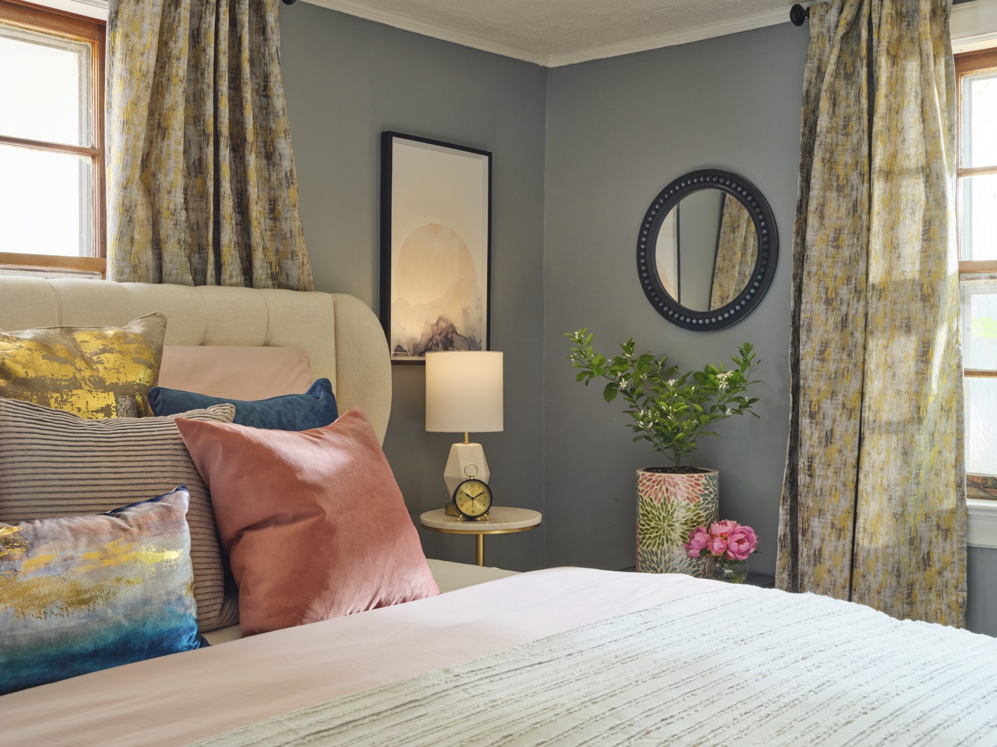 Bedside table with a clock and a lamp