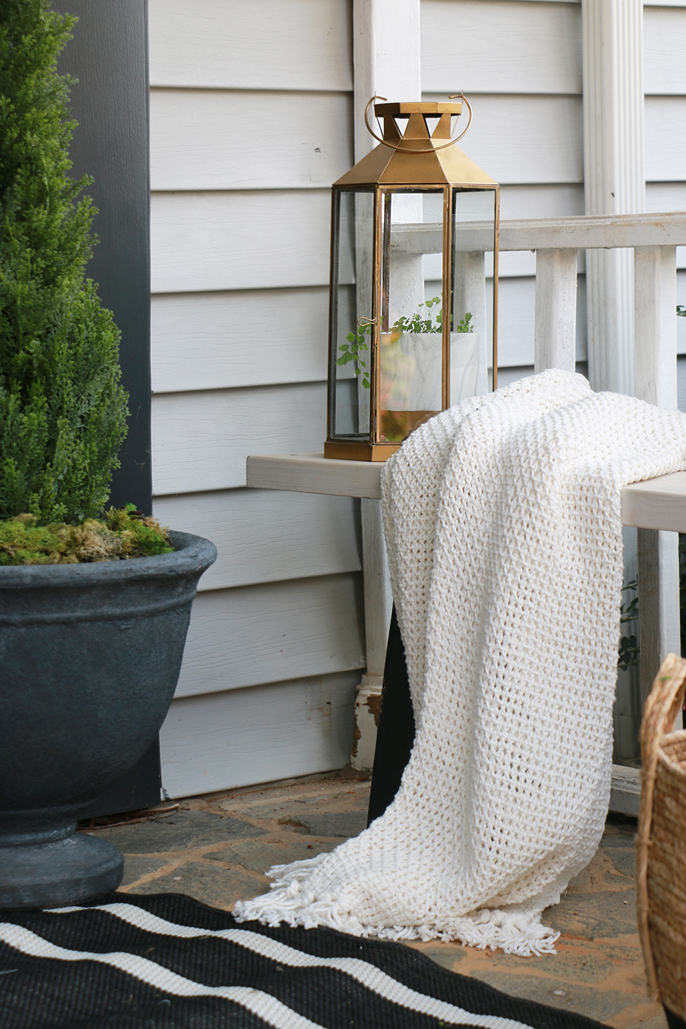 Throw blanket draped on front porch bench